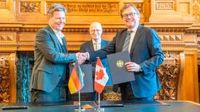 Bundeswirtschaftsminister Robert Habeck (links) und Jonathan Wilkinson, Minister für Energie und natürliche Ressourcen Kanada, unterzeichnen einen Letter of Intent im Beisein von Hamburgs erstem Bürgermeister Peter Tschentscher. 